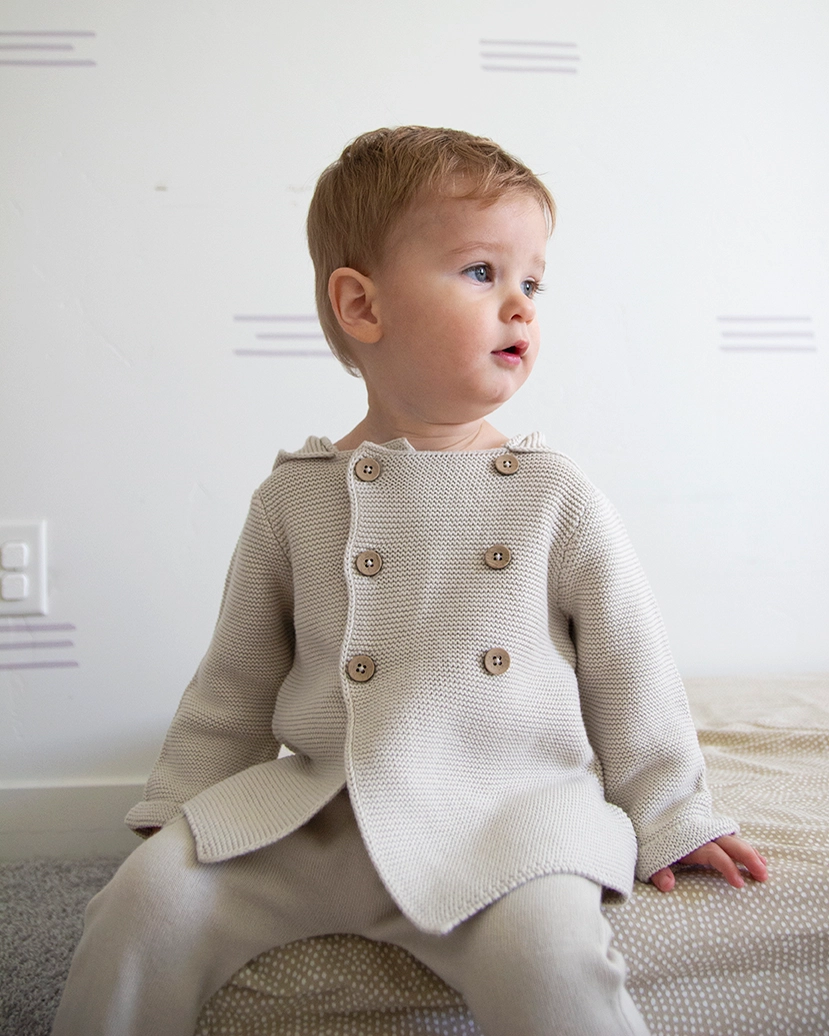 Hooded Double Button Baby Jacket, Stone Organic Cotton this Sweater Shown in 6 to 12 months.

Call for available Sizes, 303-744-7464
